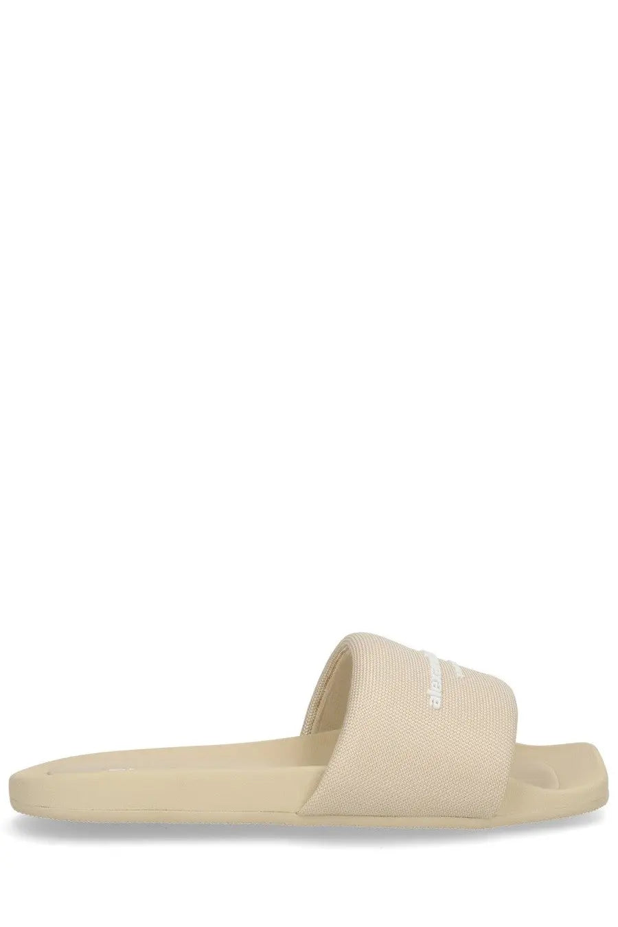 Beige canvas slide sandal with minimalist design and subtle brand logo on strap for women by Alexander Wang