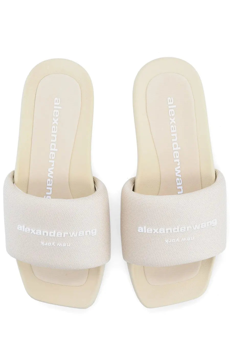 Cream-colored alexander wang slide sandals with textured fabric strap and minimalist branding for women slip on use