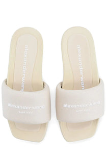 Cream-colored alexander wang slide sandals with textured fabric strap and minimalist branding for women slip on use