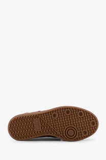 Brown rubber sole with wavy tread and circular grip dots on red aloha women’s tb suede sneakers with rugby label