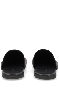 Alysi women’s mule slide sandals in black suede with minimalist design and subtle branding on the insole