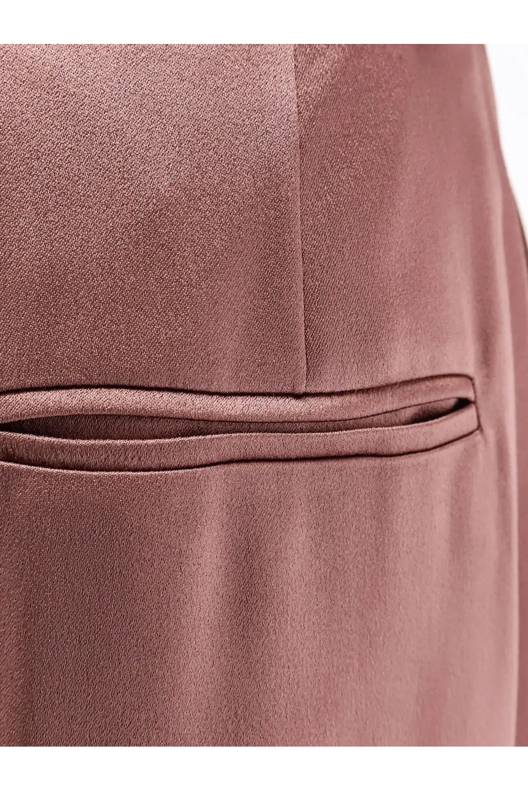 Alysi women’s satin trousers blue showing close-up of rose gold satin fabric with stitched pocket detail and subtle sheen