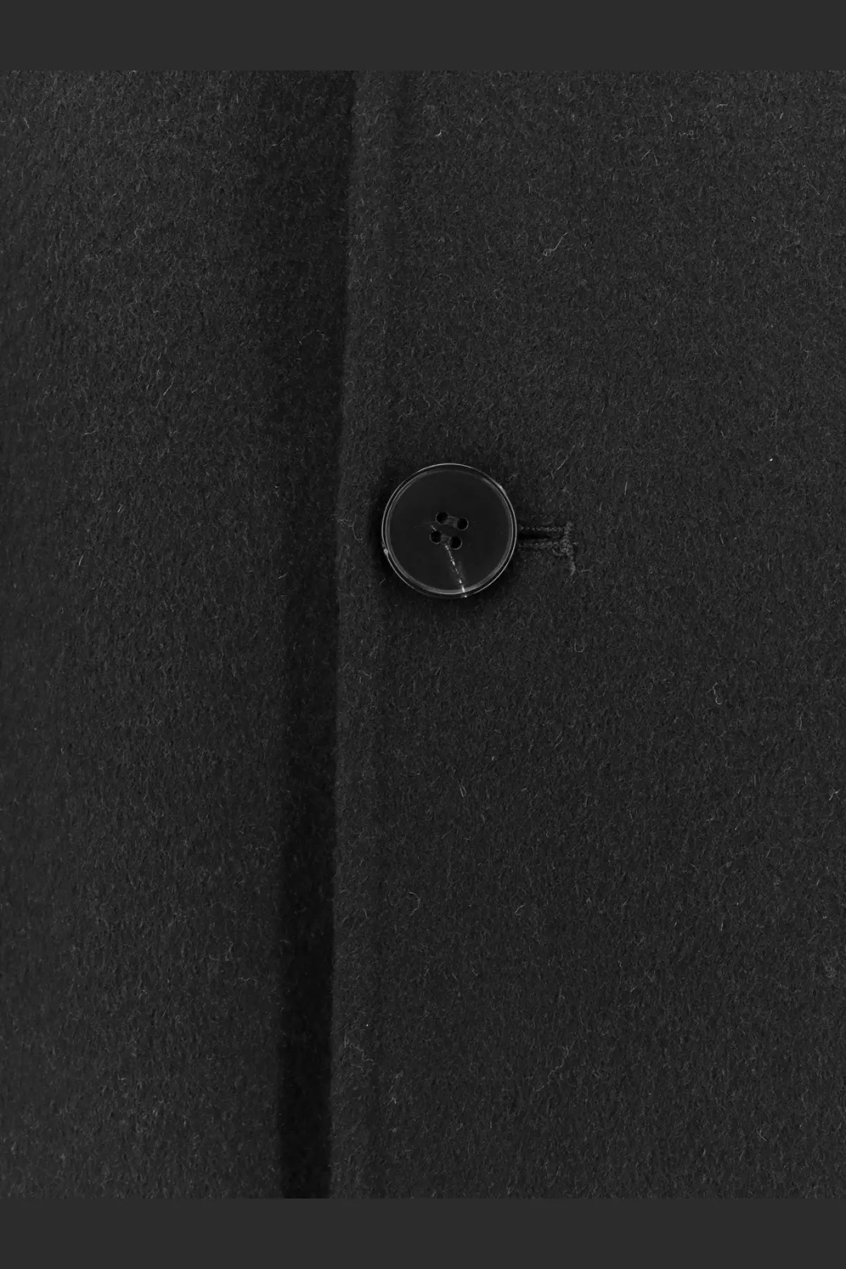 Black circular matte button on dark fabric of amaranto men’s outdoor black wool coat