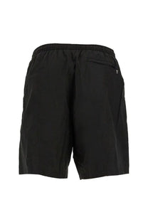 Back of ami paris men’s boxer swimsuit black showing elastic waistband and small zippered pocket on black athletic shorts