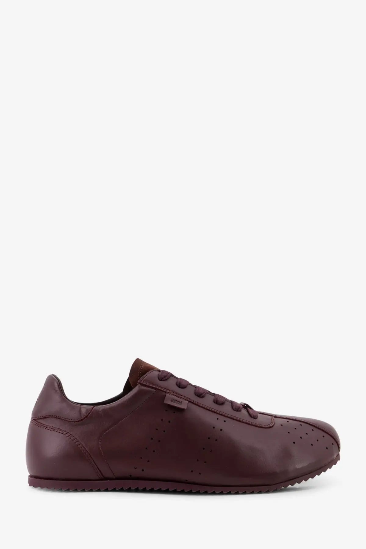 Ami Paris men’s leather low top sneaker in burgundy with perforated detailing and a textured rubber sole