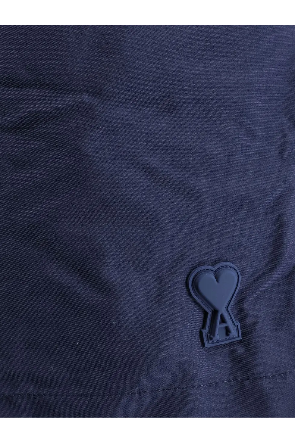 Dark navy ami paris men’s nylon swimsuit with matte black heart-shaped logo patch embossed with a inside