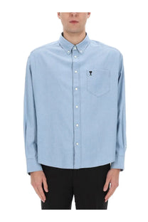 Ami Paris men’s light blue button-down shirt with subtle embroidered logo on chest pocket suitable for casual wear