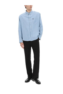 Light blue ami paris men’s long-sleeved button-down shirt with small embroidered logo on the chest pocket