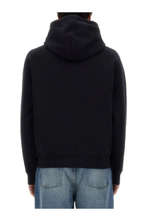 Ami Paris unisex black hoodie with soft textured fabric and ribbed cuffs for comfortable casual wear