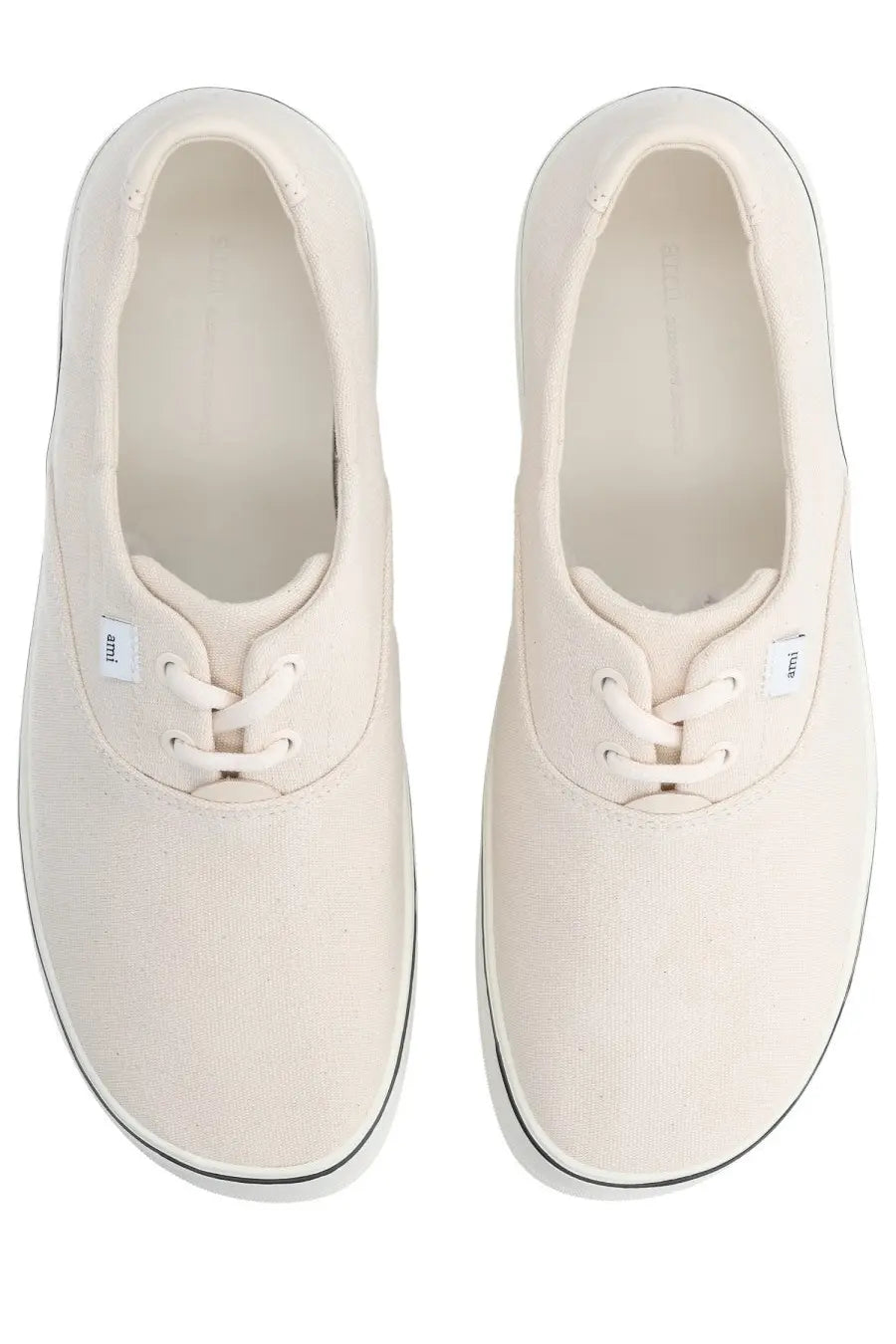 Cream-colored canvas Ami Paris unisex tennis sneakers with black rubber soles and white laces