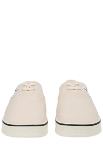 Cream-colored canvas ami paris unisex tennis sneakers with black rubber soles and laces for casual wear