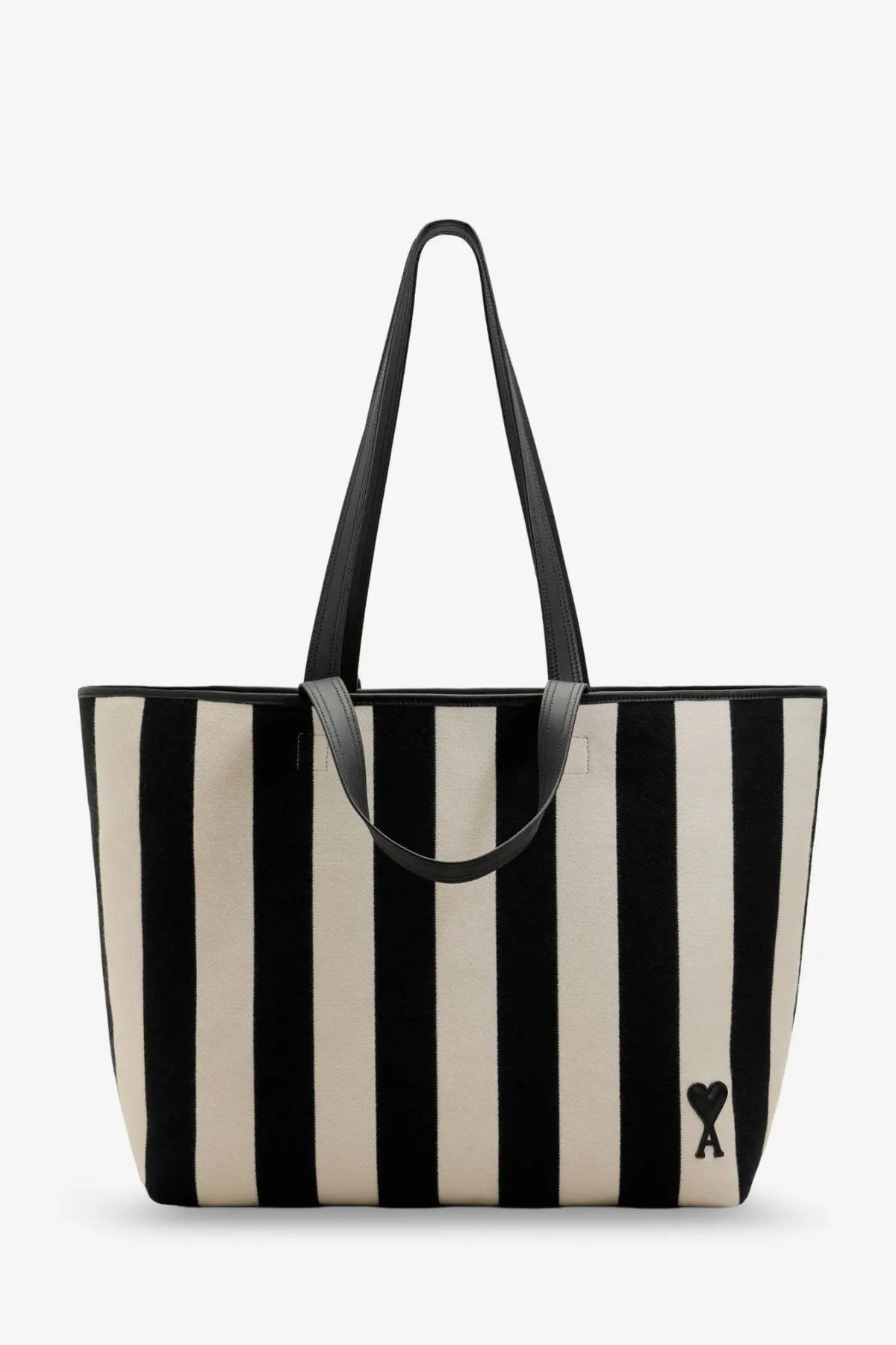 Ami Paris women’s Ami de Coeur canvas shopping bag with black and cream stripes, black leather handles, and heart logo