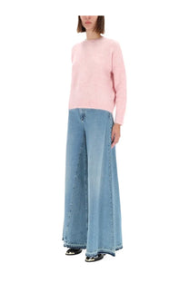 A soft pink long-sleeved knit sweater with a round neckline shown with Amish supplies women’s Colette rinse jeans blue