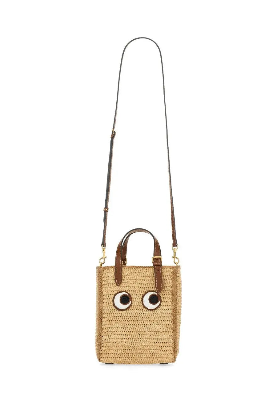 Anya Hindmarch women’s beige woven straw tote bag with brown leather handles and cartoon eyes on front