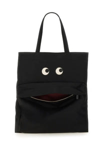 Anya Hindmarch women’s black tote bag with playful googly eyes and a zipper-mouth design