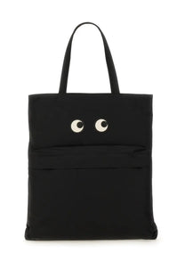 Anya Hindmarch women’s black tote bag featuring playful white and black embroidered eyes on the front