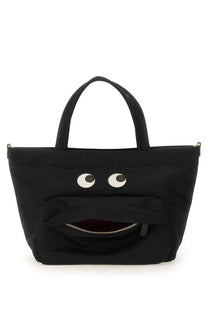 Anya Hindmarch women’s black canvas tote bag with playful white eyes and zipper-mouth design in mini size