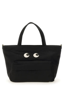 Anya Hindmarch women’s black canvas tote bag with playful white and black embroidered eyes on the front