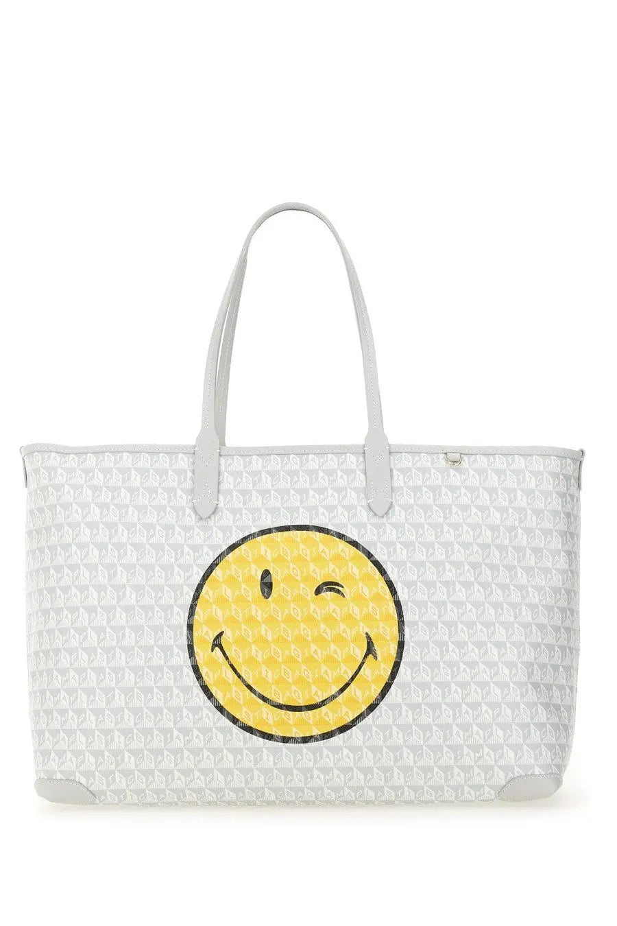 Anya Hindmarch women’s white tote bag with repeating geometric pattern and large yellow winking smiley face on front
