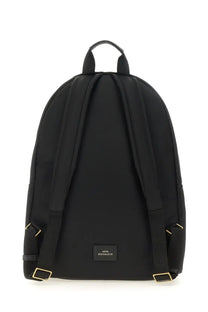 Anya Hindmarch women’s black nylon backpack with gold-tone hardware and small rectangular brand label at the base