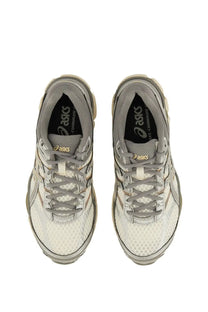 Gray and white Asics unisex gel Cumulus sneaker with mesh upper, rubber sole, and gold logo accents