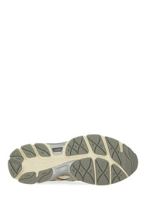 The sole of a gray and beige asics unisex gel cumulus sneaker with textured patterned outsole design