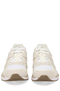 Cream-colored asics unisex gel nyc sneaker with white mesh suede accents and chunky beige tan sole