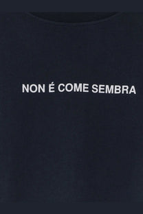 Black cotton t-shirt with white embroidered non é come sembra text featured in aspesi men’s cotton shirt blue collection