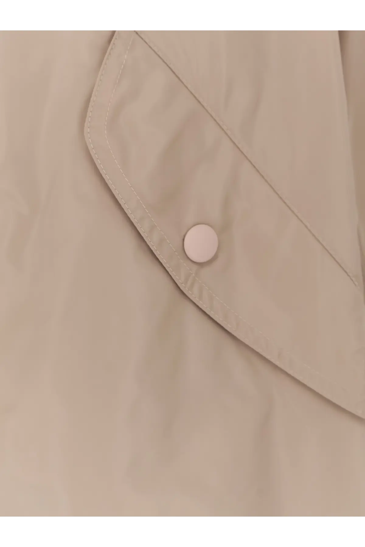 Beige aspesi women’s bombo nylon jacket pocket flap with matching button detail on fabric texture close-up