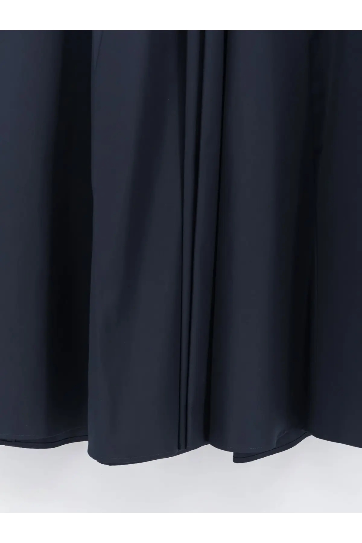 Dark navy pleated curtain fabric shown as a backdrop for aspesi womens long blue cotton skirt product display