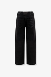 The back side of the attico womens black denim trousers featuring wide-leg fit and subtle stitched detailing on back pockets