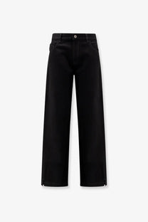 The Attico women’s black denim trousers featuring wide-leg silhouette and subtle side zippers at the hem