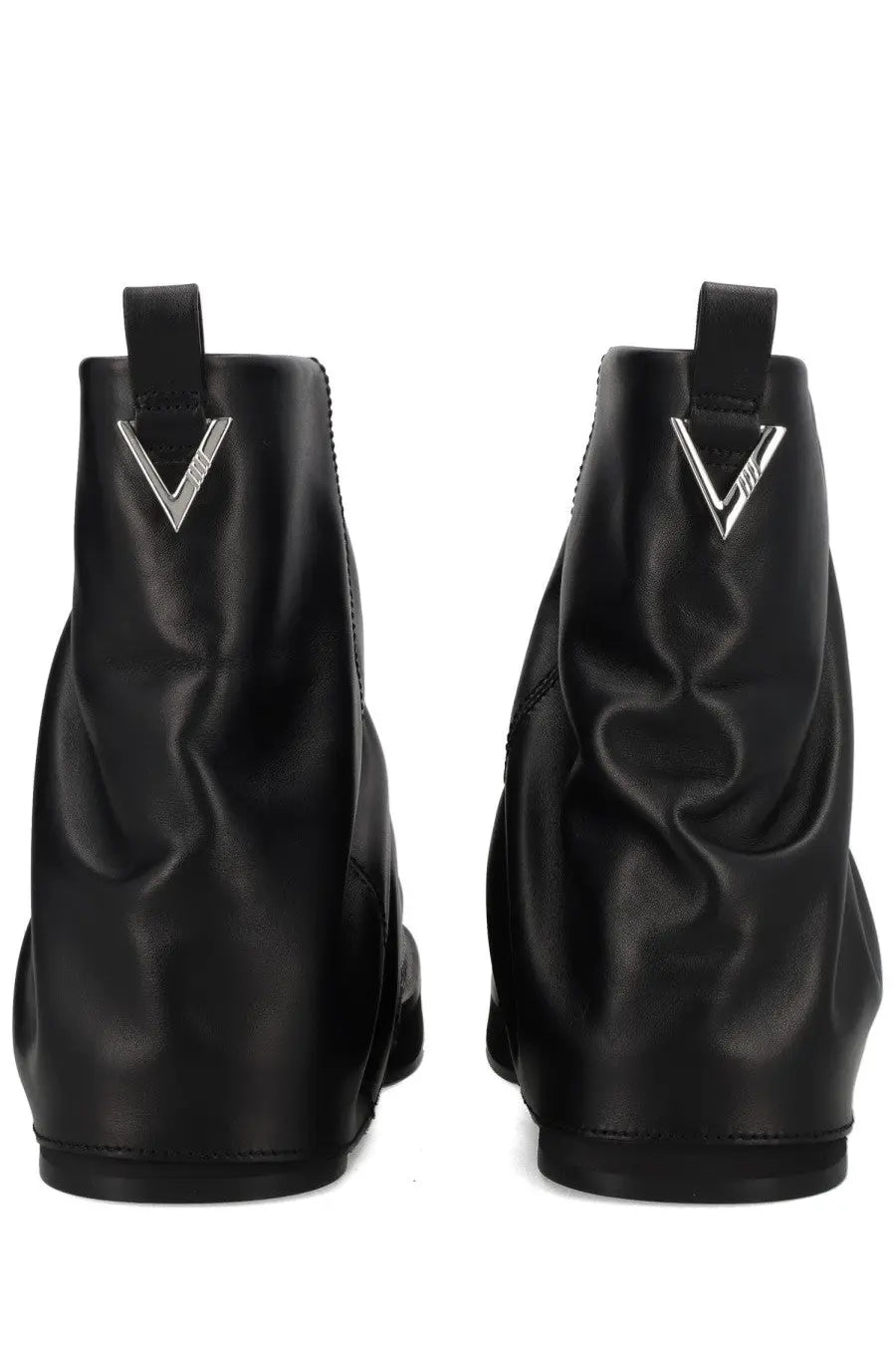 The back side of the attico women’s black leather ankle combat mini robin boot with a glossy finish and silver v logo