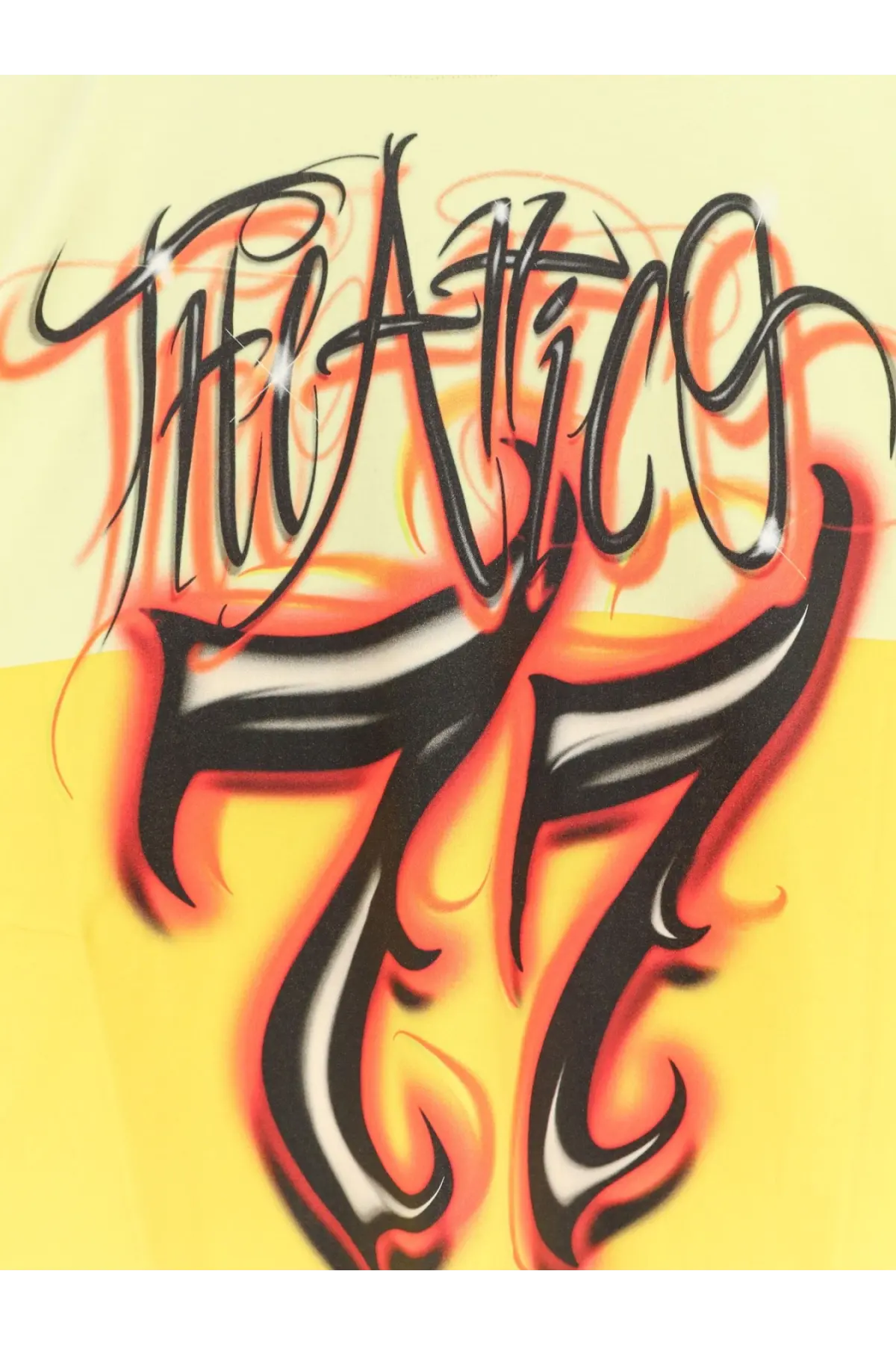 The attico women’s cotton shirt gold featuring the alice 77 graffiti style logo in bold black orange and white