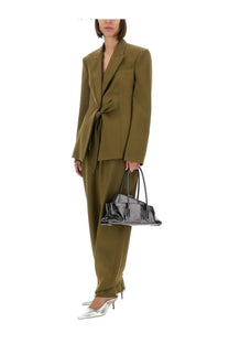 Black patent leather handbag with structured silhouette and dual top handles featured with The Attico women’s green gabardine jacket