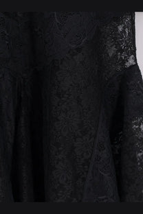 The attico women’s lace dress black featuring intricate floral patterns and flowing sheer fabric in black