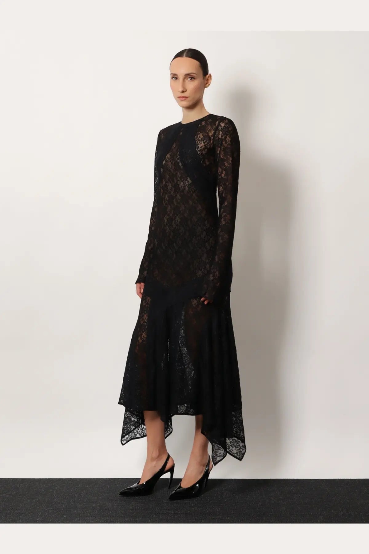 The Attico women’s black lace dress with long sleeves and an asymmetrical hemline showcases elegant design