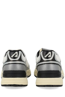 Back view of autry men’s hyperway sneaker white in silver and black with honeycomb heel pattern and cream rubber sole