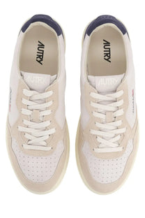 Autry men’s Medalist low sneaker in white and beige suede with navy blue accents and perforated toe panels