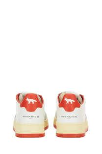 Back view of autry men’s medalist low sneaker in white with red accents and fox logo on heel for casual wear