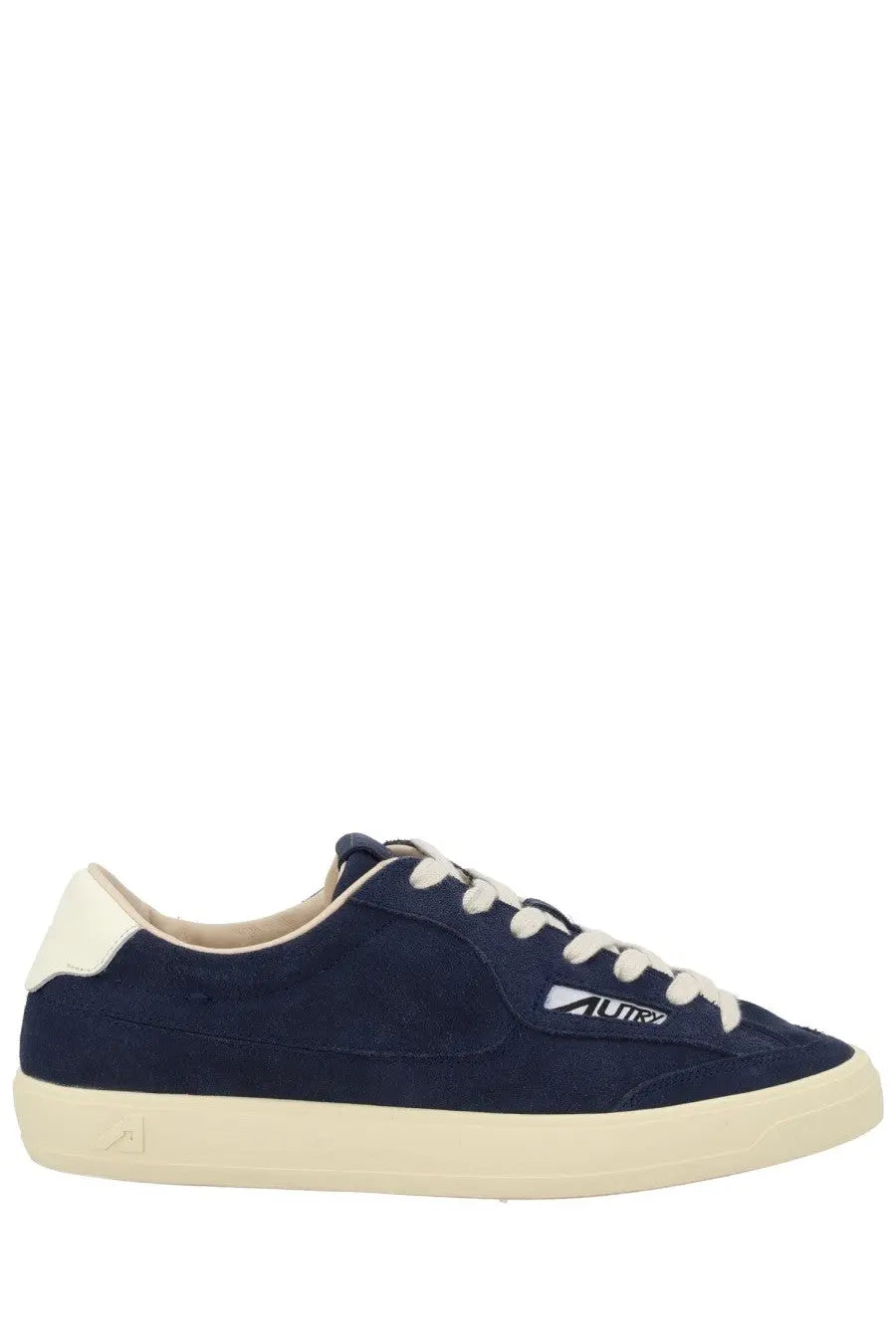 Navy blue suede low-top sneaker with cream laces rubber sole and white logo on the side by Autry