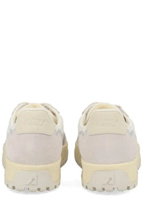 Autry men’s wildpace low sneaker in cream-colored suede with chunky rubber sole and subtle gray patterned accents