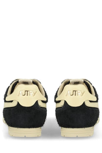 Back view of autry men’s windspin sneaker black in black and cream suede with retro textured design and autry logo on heel