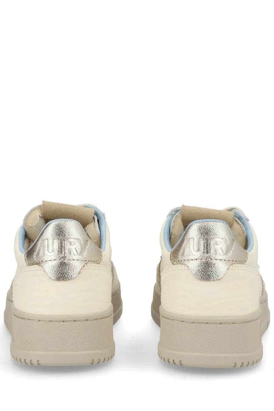Cream-colored Autry women’s Medalist low sneakers with metallic silver heel tabs embossed with urb branding visible from back