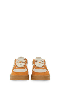 Autry women’s medalist low sneaker in orange and white suede with a gum rubber sole