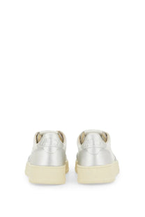 Back view of autry women’s medalist low silver metallic sneakers with cream rubber sole and embossed brand heel