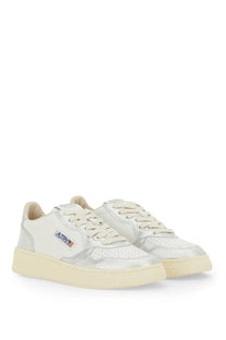 Autry women’s medalist low sneaker in white and silver metallic leather with cream laces and subtle autry logo