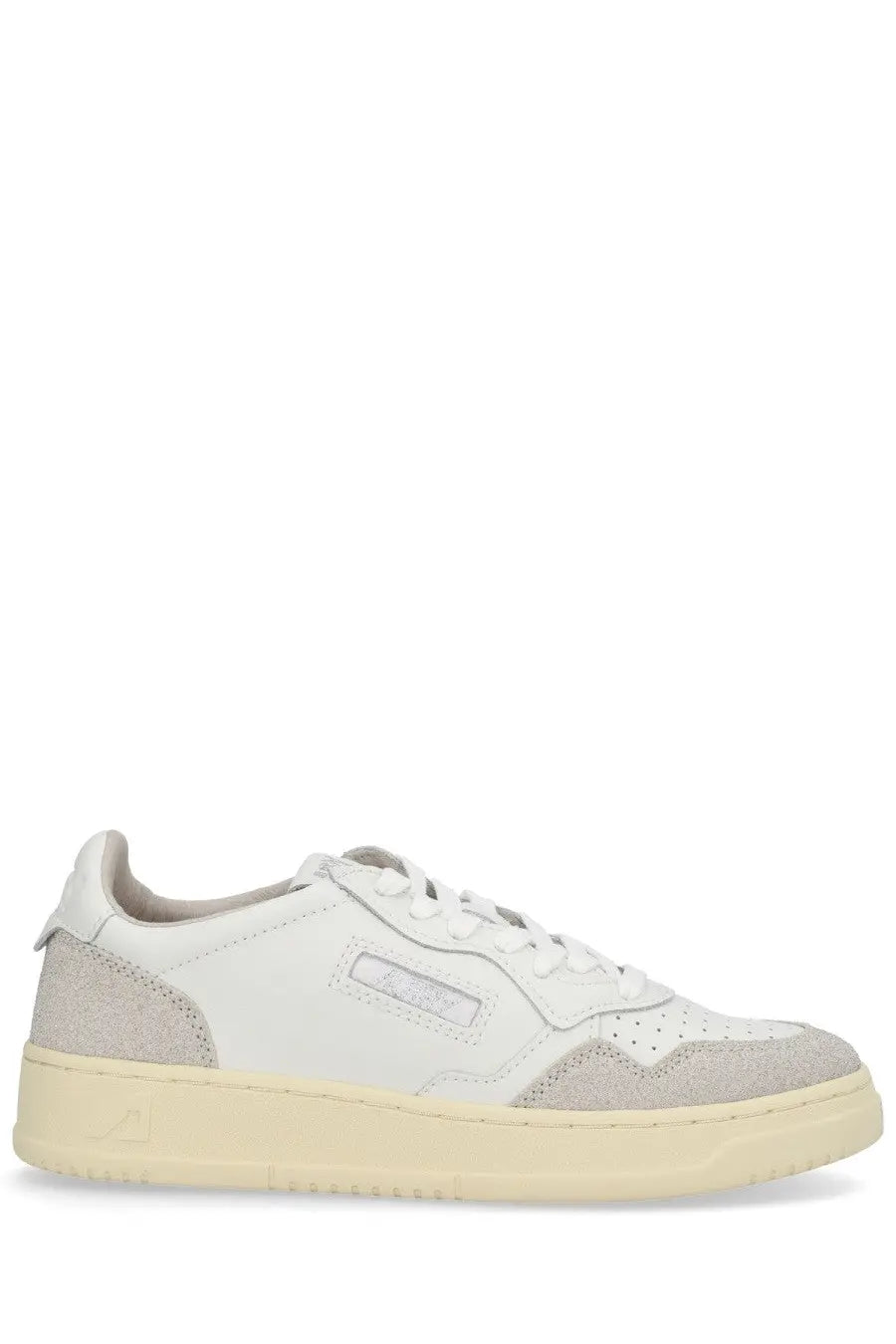 Autry women’s Medalist low sneaker in white featuring beige suede and leather with a cream rubber sole