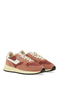 Pair of autry women’s reelwind low sneakers in dusty rose suede and canvas with white laces and cream midsoles