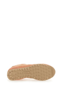 Beige suede puma sneaker with tan rubber sole and classic triangular tread pattern in autry women’s windspin low sneaker multicolor